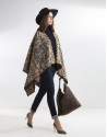 Beige poncho with black trim