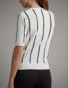 Black and white striped sweater and crossover neckline