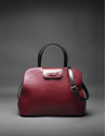 Bolso  Ryan en piel rígida burdeos combinada con negro