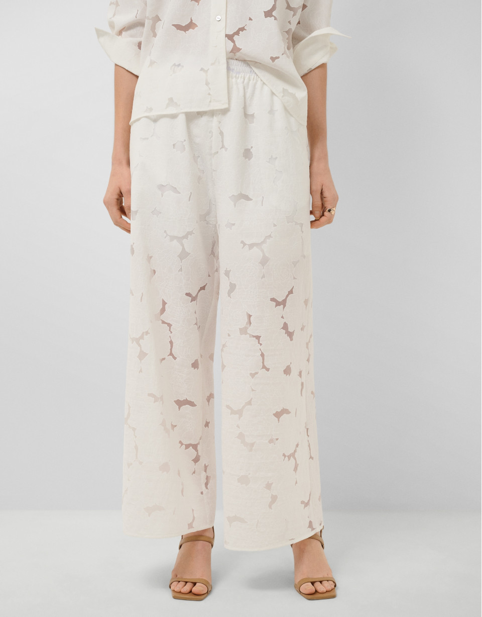 White devoré palazzo trousers with floral print | Roberto Verino