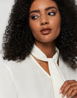 Beige blouse with V-neck and bow