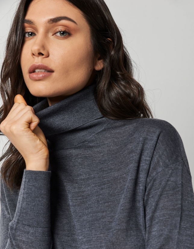 Dark grey fine knit sweater with turtleneck.