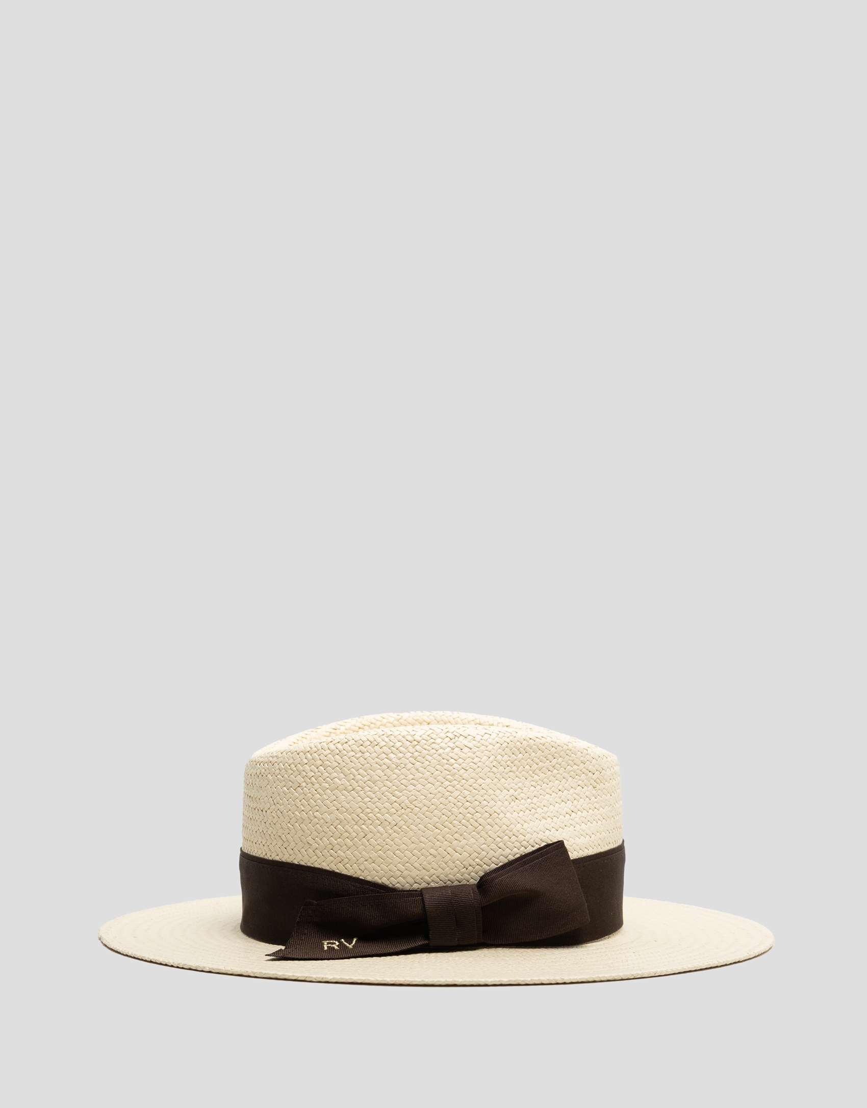 Beige hat with narrow brim and brown ribbon