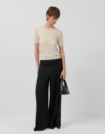 Wide-legged black crepe trousers with slit