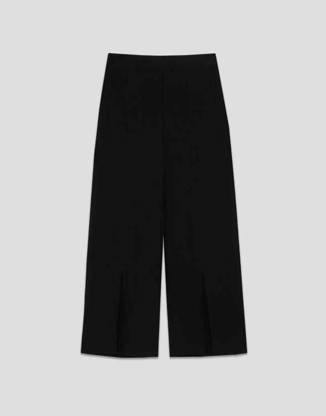 Wide-legged black crepe trousers with slit