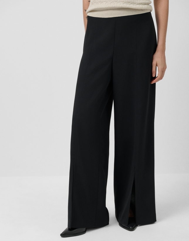 Wide-legged black crepe trousers with slit