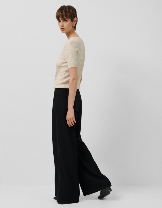 Wide-legged black crepe trousers with slit