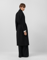 Long double-breasted coat in black cloth.