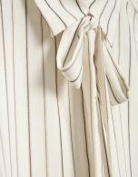 Beige striped shirt with bow at the neck