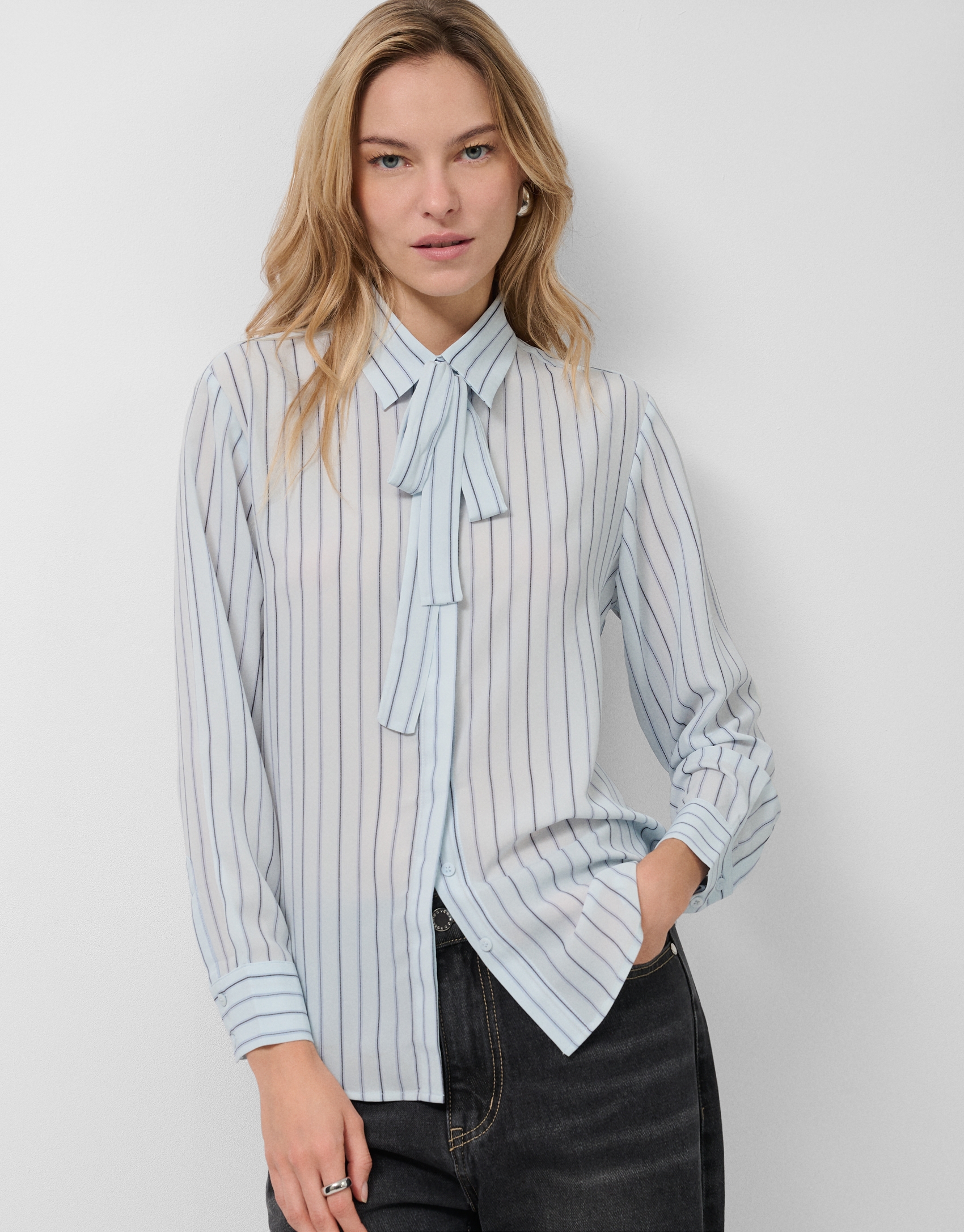 Blue striped shirt with bow at the neck