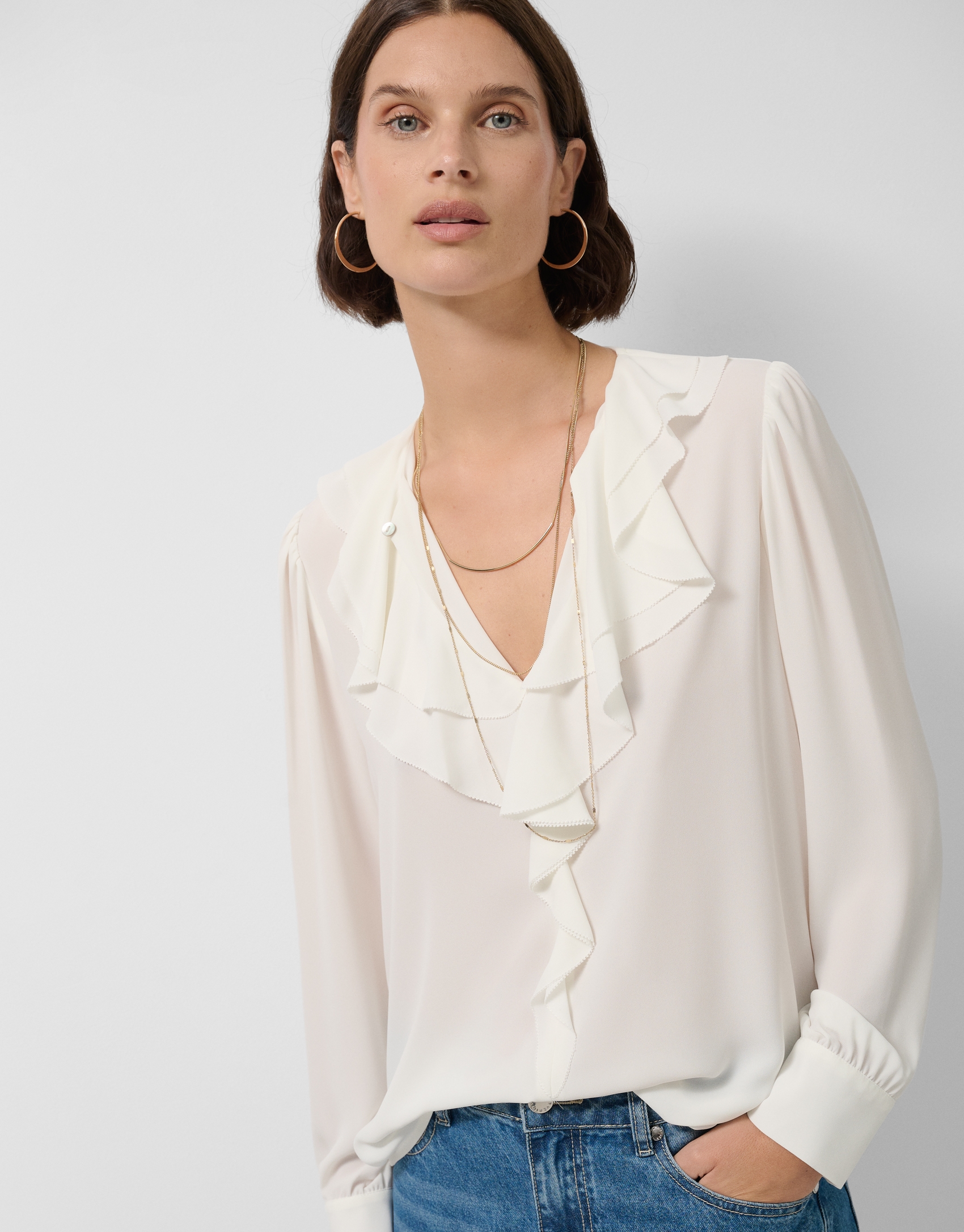 Ecru long-sleeved blouse with ruffle