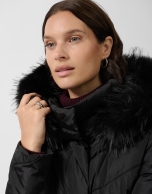Long black down jacket with removable hood and faux fur