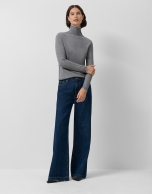 Grey double-edged funnel neck sweater.