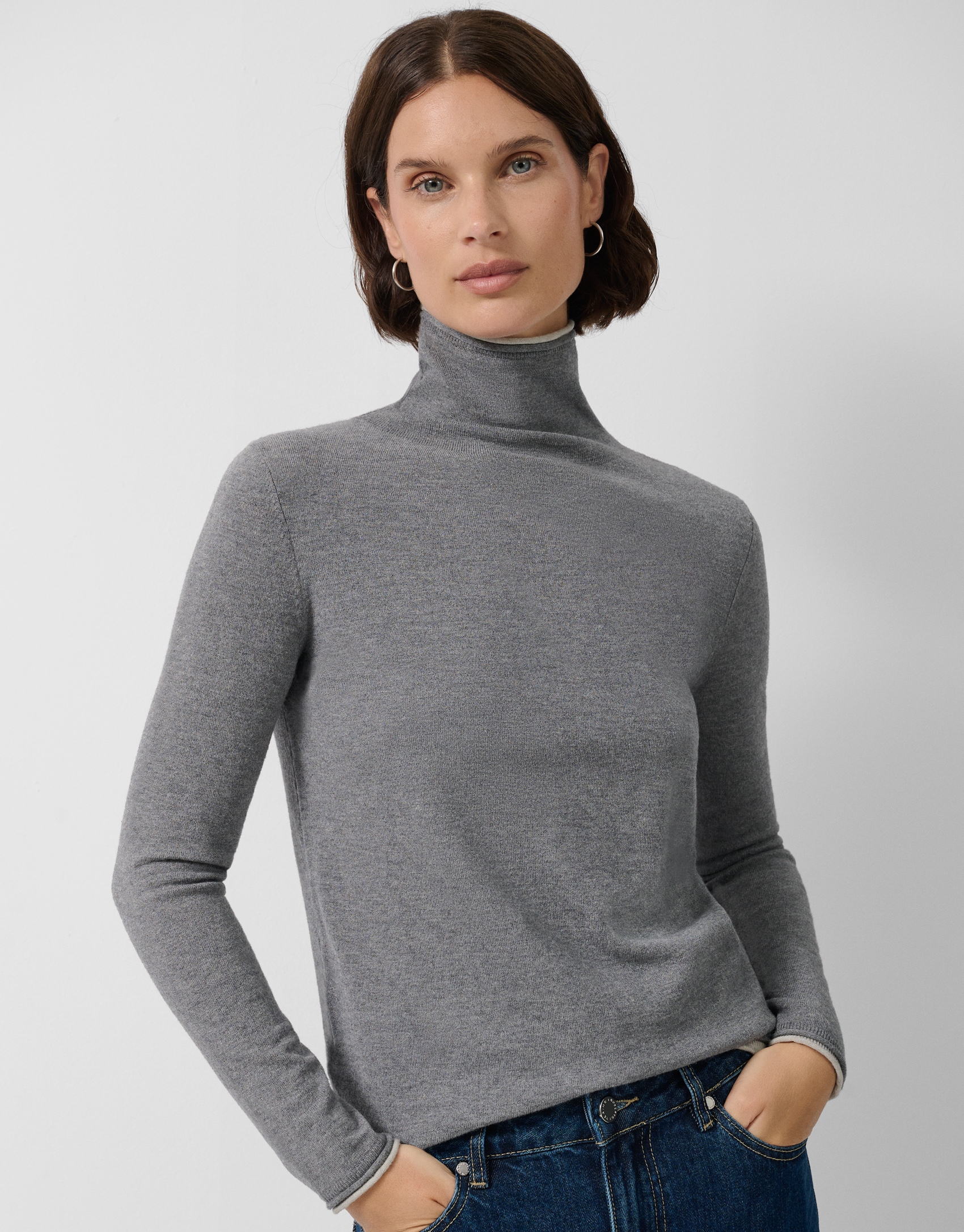 Grey double-edged funnel neck sweater.
