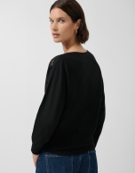 Black fine knit sweater with embroidered lace flowers on the sleeves