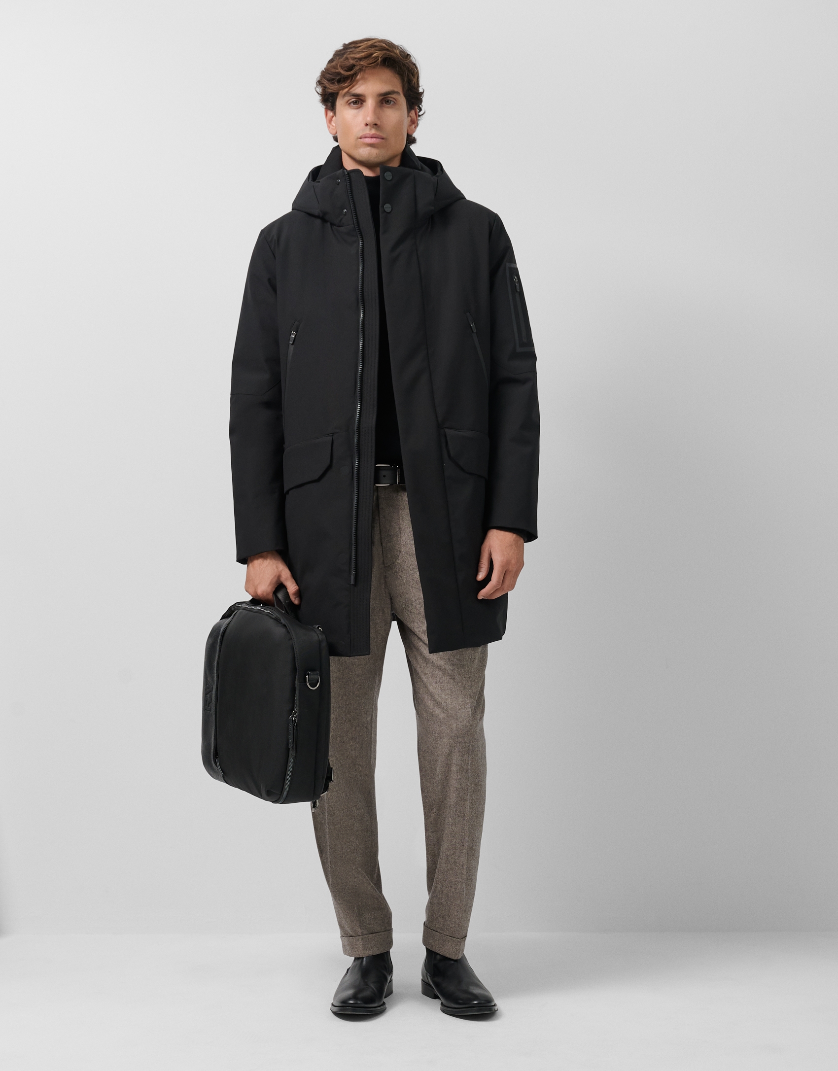 Long black quilted technical trench coat