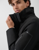 Long black quilted technical trench coat