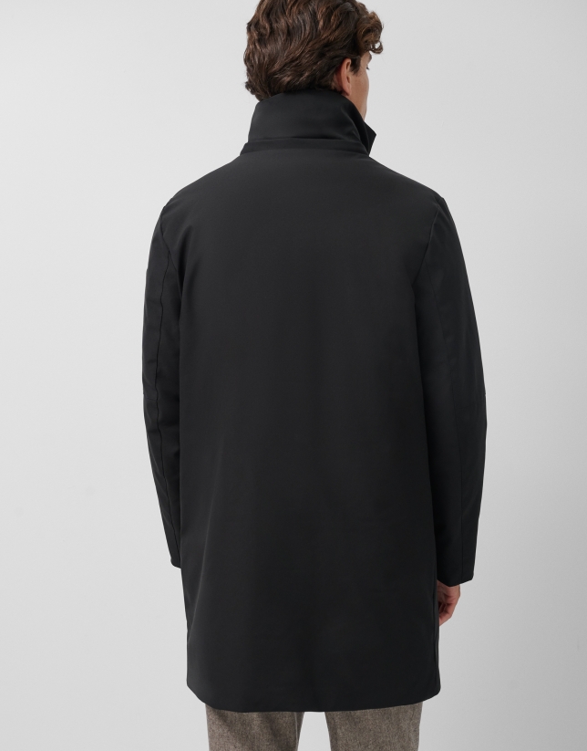 Long black quilted technical trench coat