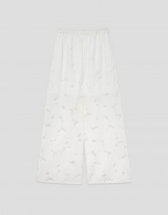 White devor&eacute; palazzo trousers with floral print