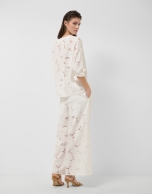 White devor&eacute; palazzo trousers with floral print