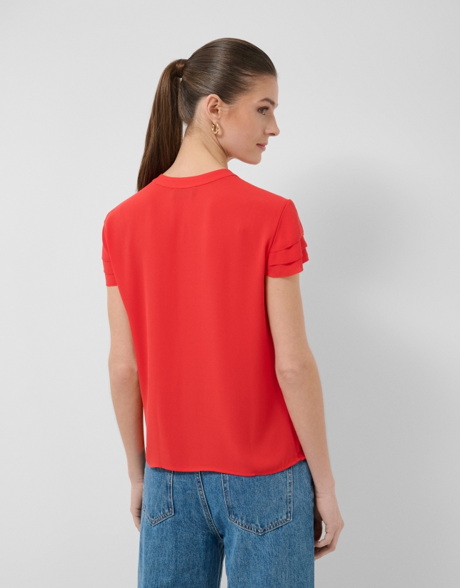 Red short-sleeved blouse with ruffles