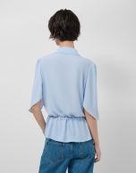 Light blue ruffled sleeve blouse with gathered waist
