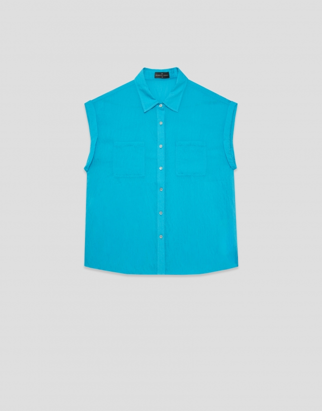 Turquoise sleeveless blouse with pockets
