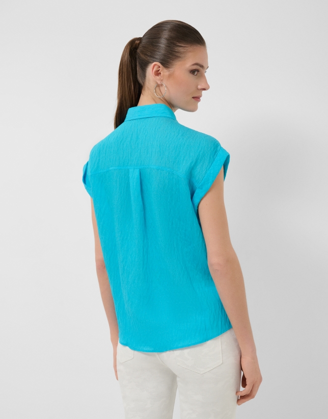 Turquoise sleeveless blouse with pockets
