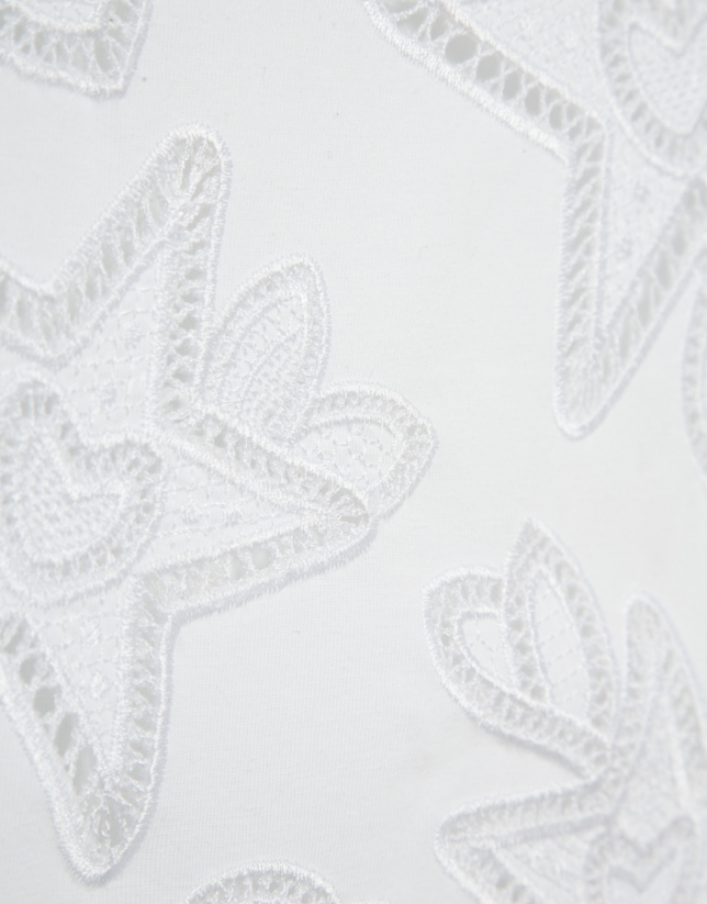 Oversized white sleeveless T-shirt with stars and leaves