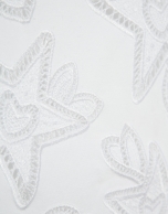 Oversized white sleeveless T-shirt with stars and leaves