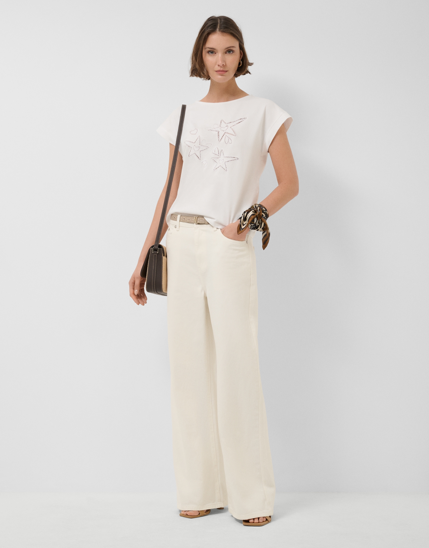 Oversized white sleeveless T-shirt with stars and leaves