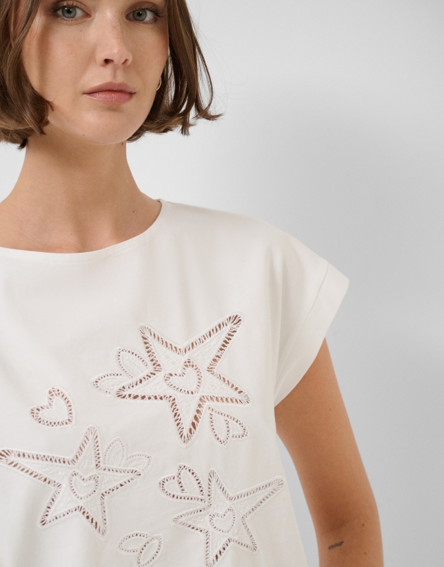 Oversized white sleeveless T-shirt with stars and leaves