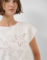 Oversized white sleeveless T-shirt with stars and leaves