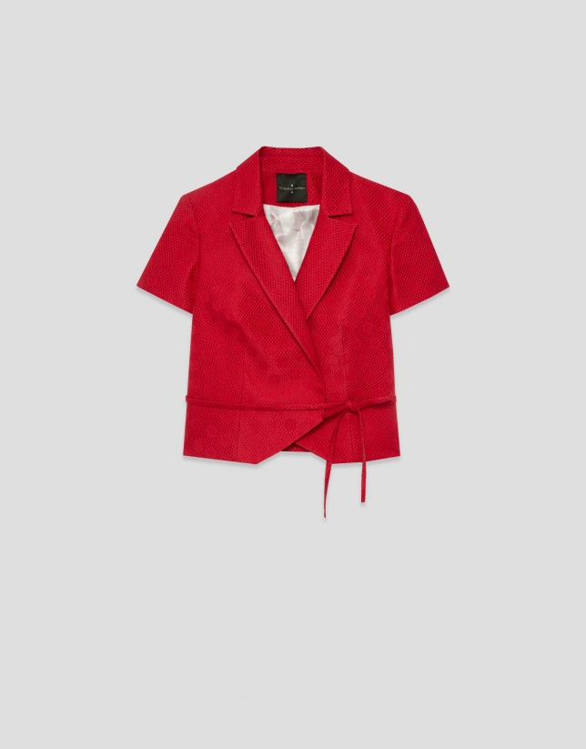 Short sleeveless jacket in red floral piqu&eacute; fabric