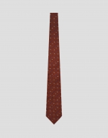 Red silk tie with geometric jacquard pattern in shades of blue