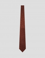 Red silk tie with navy/white geometric jacquard pattern
