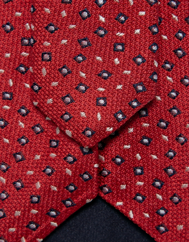 Red silk tie with navy/white geometric jacquard pattern