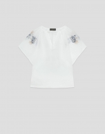 White blouse with blue floral embroidery