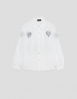 Camisa blanca con bordados azules en hombros