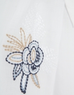 White shirt with blue embroidery on the shoulders